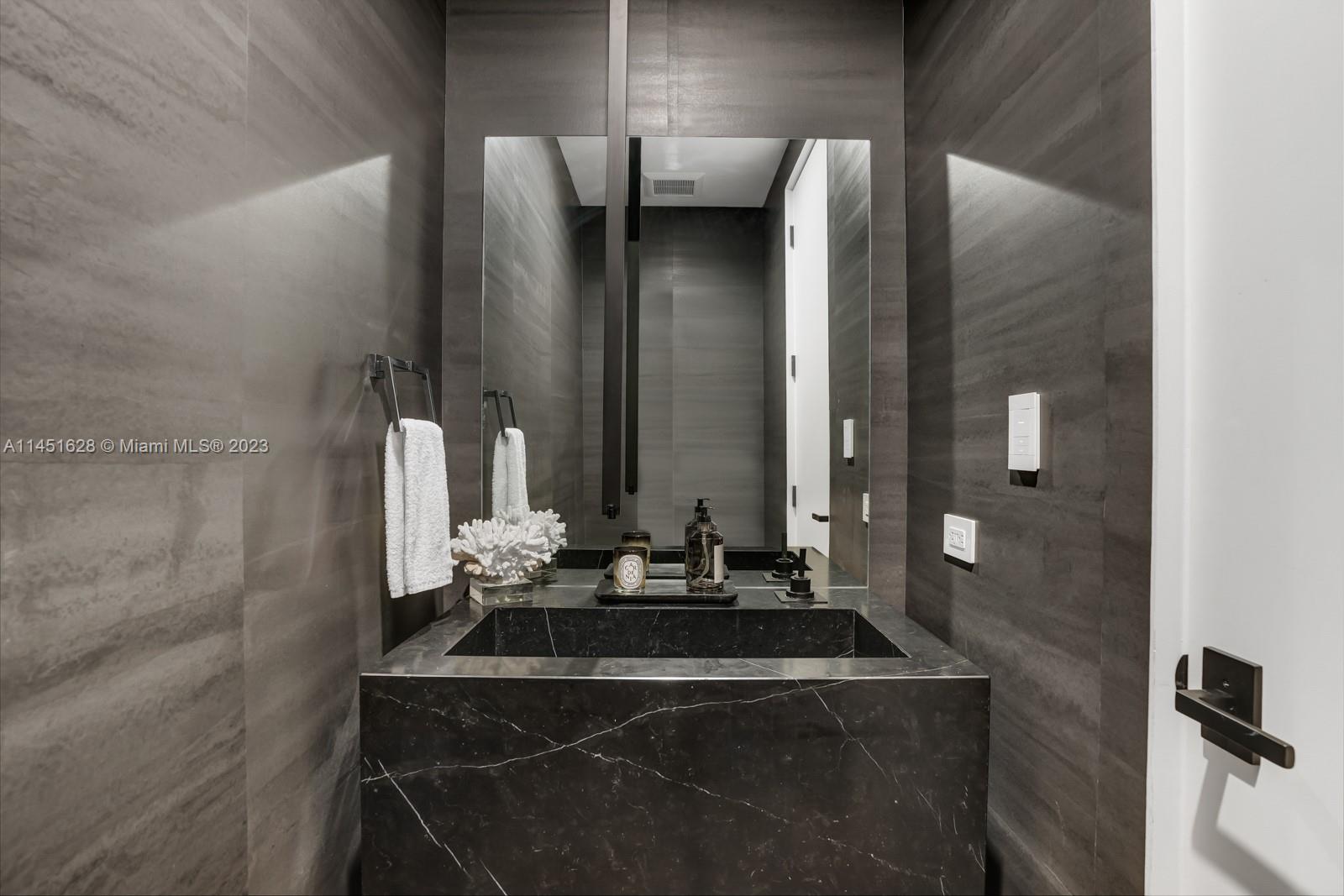 9261 School House Road Coral Gables, FL 33156 - Photo 18 of 65 a bathroom with a mirror and a sink