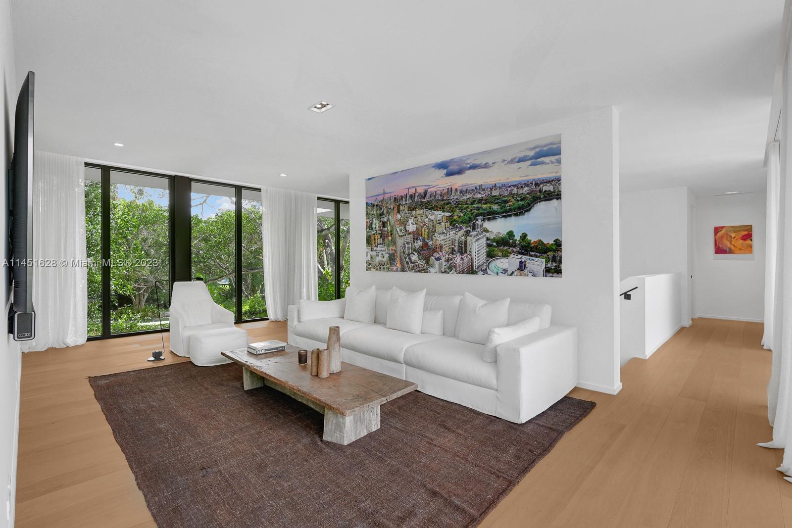 9261 School House Road Coral Gables, FL 33156 - Photo 20 of 65 a living room with furniture and large windows