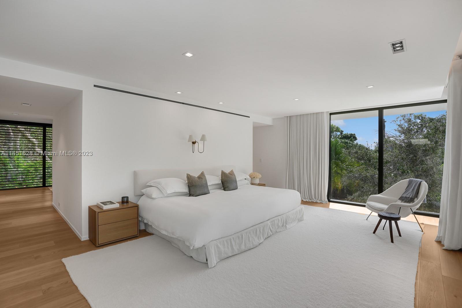 9261 School House Road Coral Gables, FL 33156 - Photo 22 of 65 a bedroom with a bed and a large window