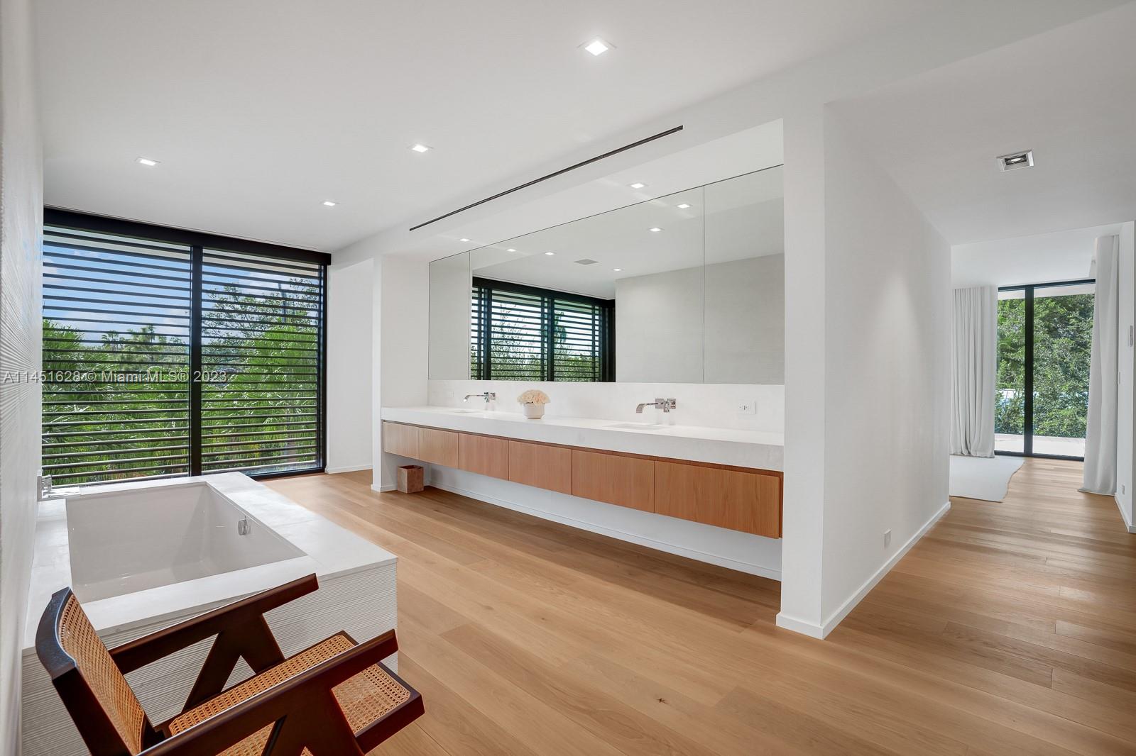 9261 School House Road Coral Gables, FL 33156 - Photo 25 of 65 a bathroom with a sink and a large mirror