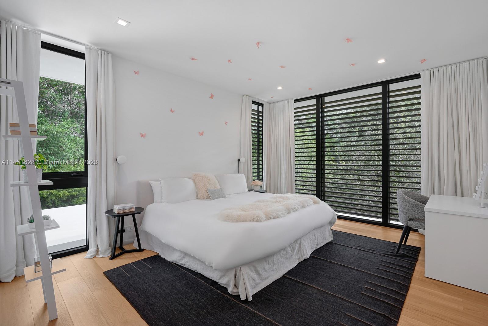 9261 School House Road Coral Gables, FL 33156 - Photo 27 of 65 a bedroom with a large bed and a window