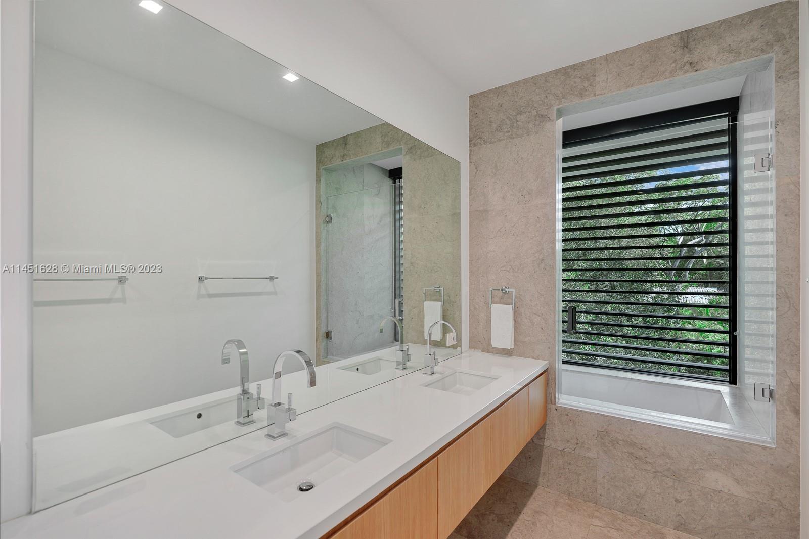 9261 School House Road Coral Gables, FL 33156 - Photo 29 of 65 a bathroom with a bathtub and a sink