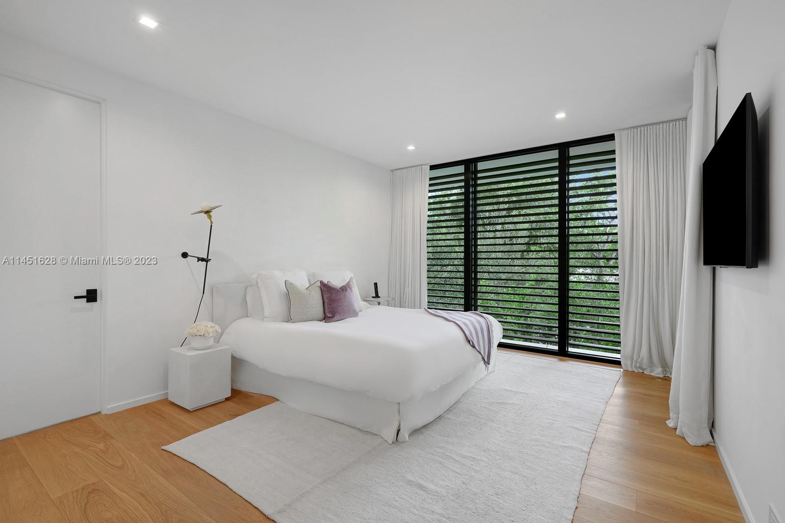 9261 School House Road Coral Gables, FL 33156 - Photo 30 of 65 a bedroom with a bed and a flat screen tv