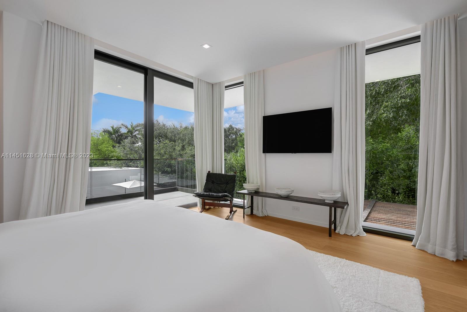 9261 School House Road Coral Gables, FL 33156 - Photo 32 of 65 a living room with couch tv and large window