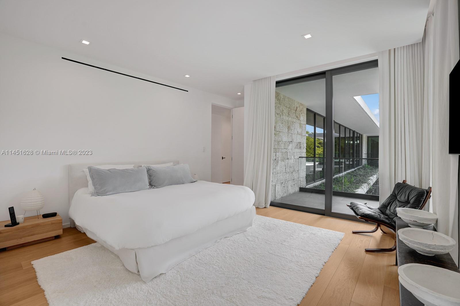 9261 School House Road Coral Gables, FL 33156 - Photo 33 of 65 a bedroom with a bed and large window