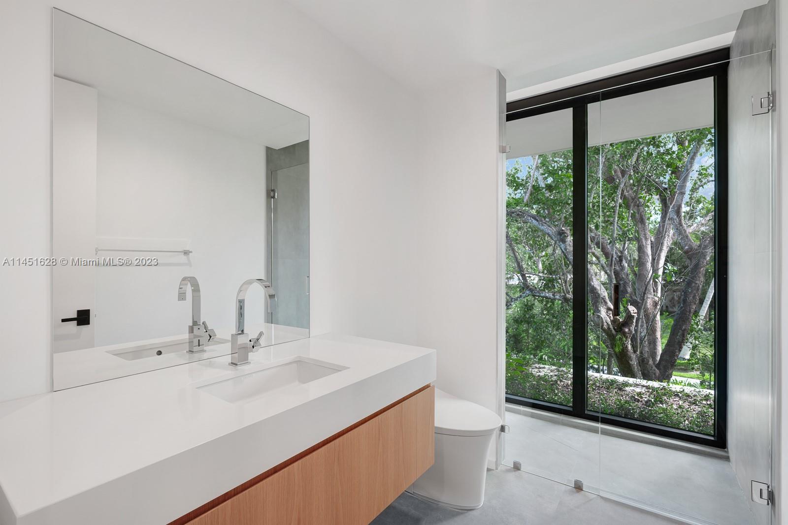 9261 School House Road Coral Gables, FL 33156 - Photo 36 of 65 a bathroom with a sink and a mirror