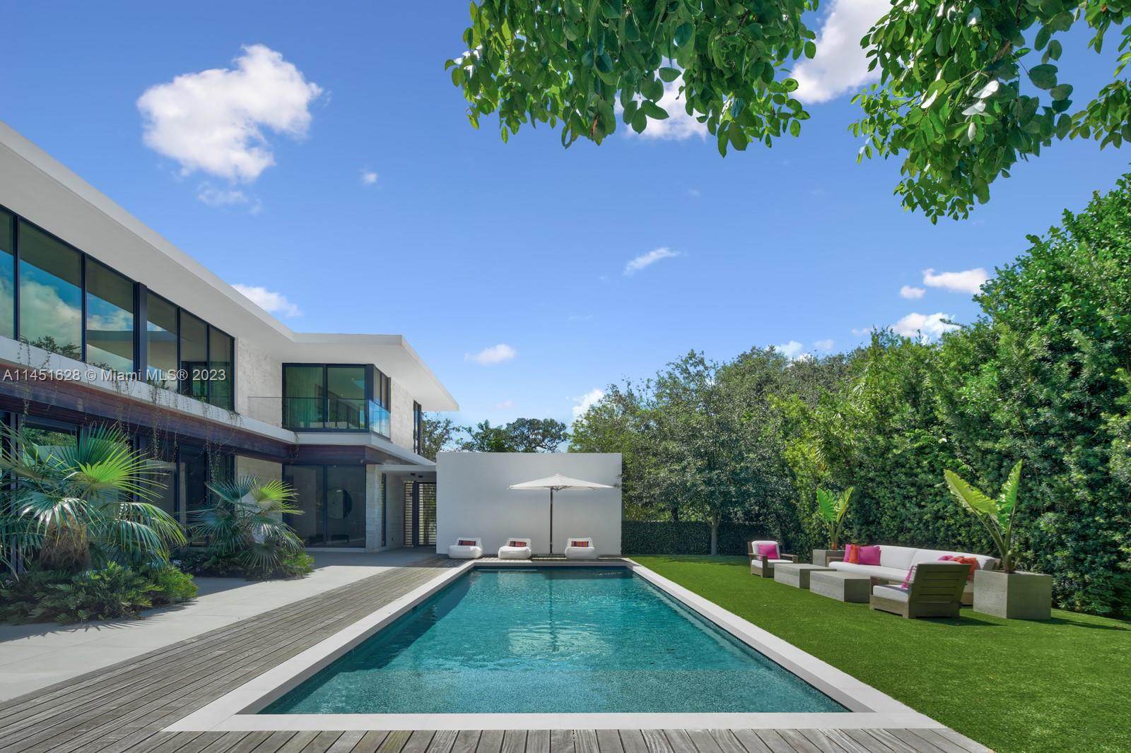 9261 School House Road Coral Gables, FL 33156 - Photo 45 of 65 a front view of a house with a yard and garage