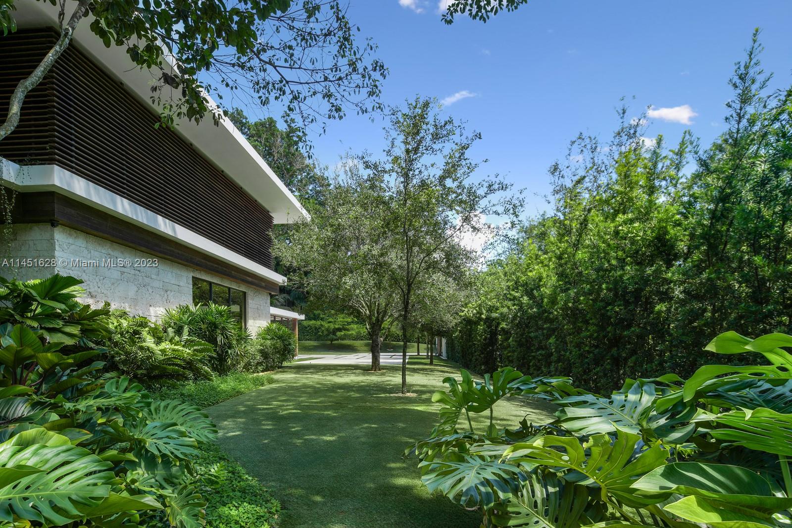 9261 School House Road Coral Gables, FL 33156 - Photo 51 of 65 a backyard of a house with lots of green space