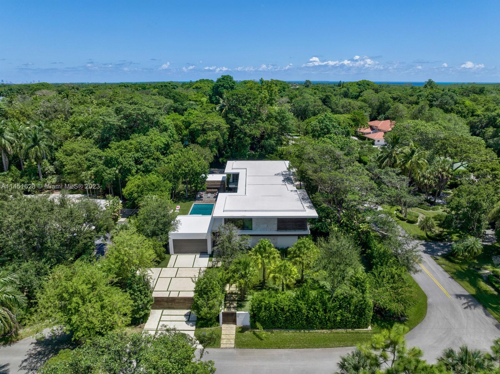 9261 School House Road Coral Gables, FL 33156 - Photo 63 of 65 an aerial view of a house with a yard