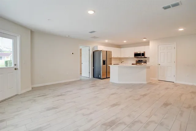 a view of a kitchen with a sink and a refrigerator