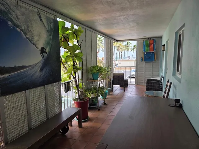 a kitchen with stainless steel appliances granite countertop a stove a refrigerator a sink a dining table and chairs