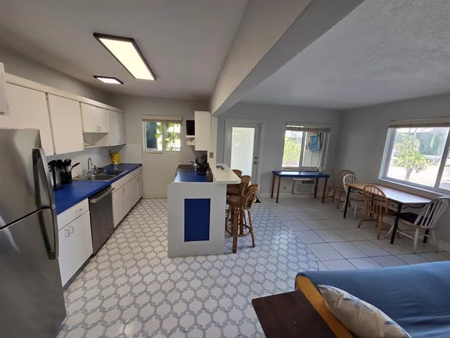 a white refrigerator freezer sitting in a kitchen