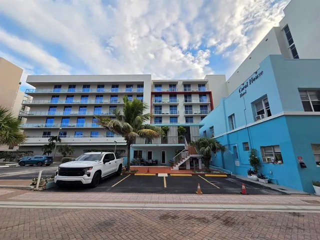 a view of a cars park in front of a building