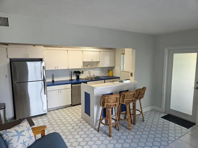 a stove top oven sitting inside of a kitchen