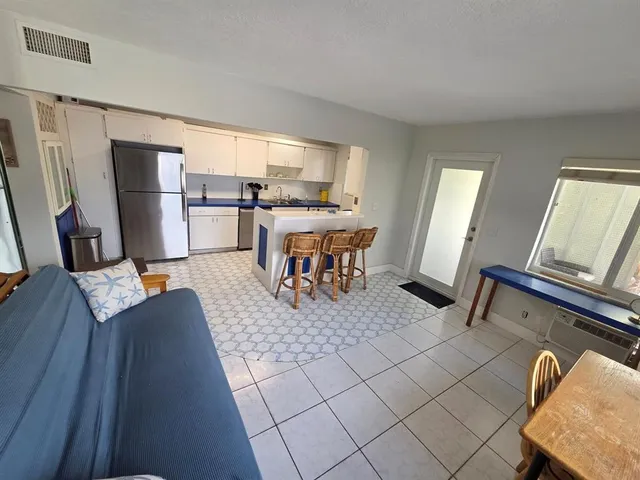 a view of a room with a large window and wooden floor