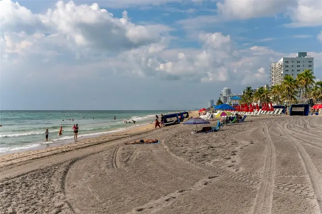 a wooden bench sitting in front of a building