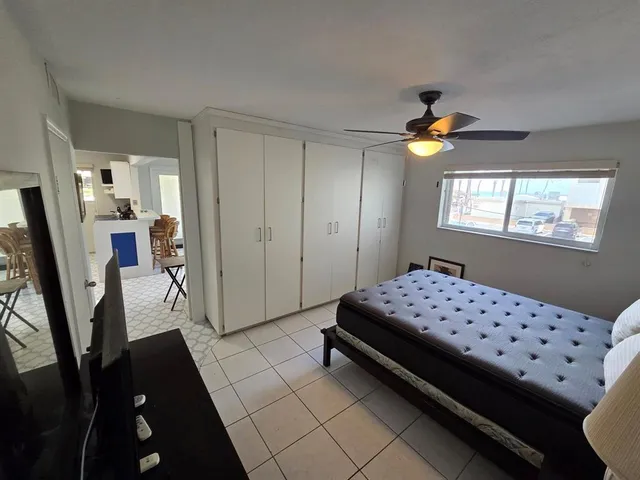 a bathroom with a sink a toilet a mirror and shower