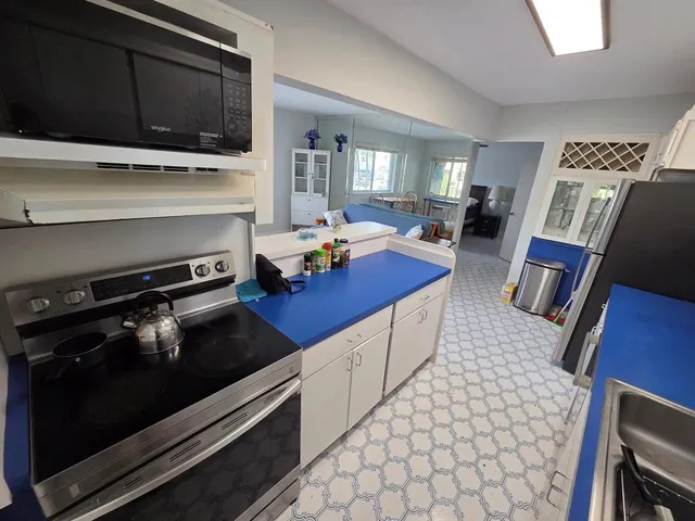 a bathroom with a sink a toilet a mirror and tub