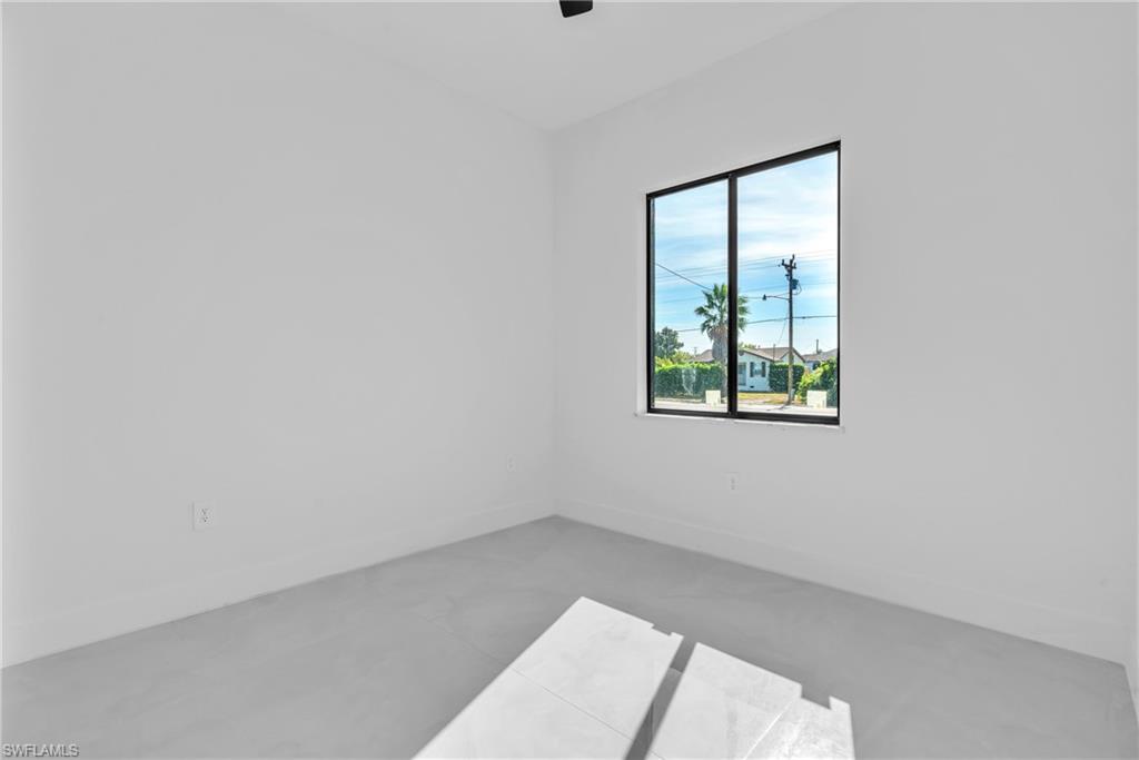 3110 23rd Street Southwest Lehigh Acres, FL 33976 - Photo 17 of 27 Empty room featuring baseboards and finished concrete flooring