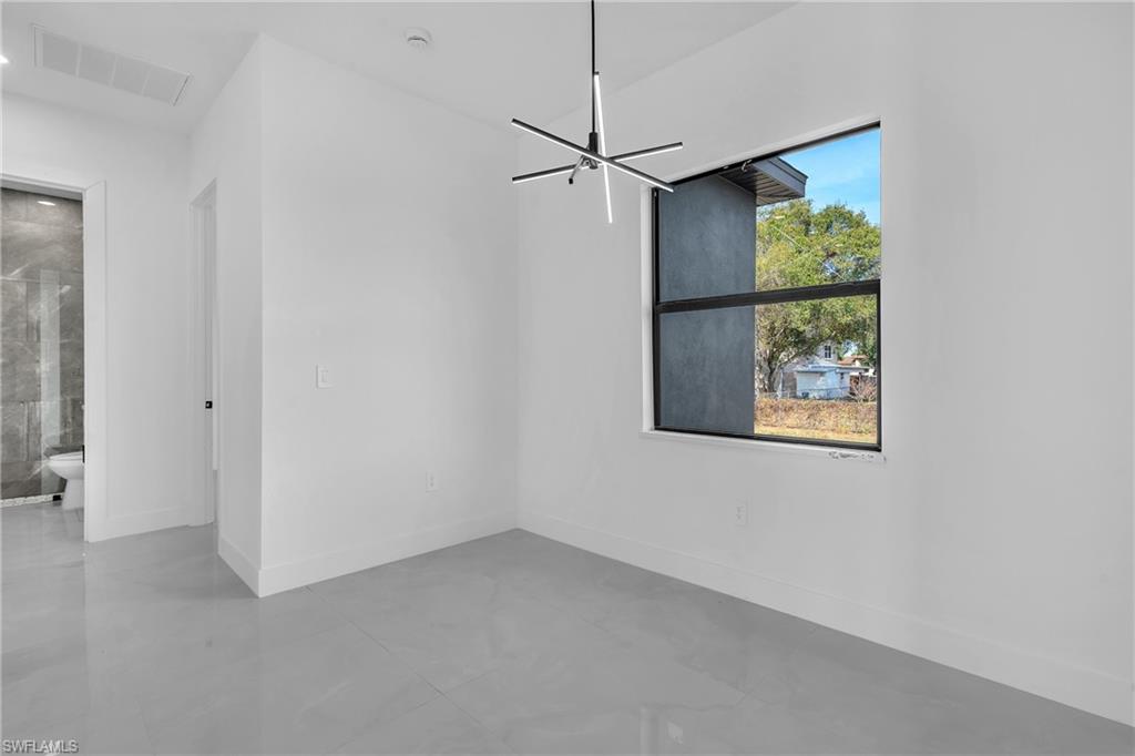 3110 23rd Street Southwest Lehigh Acres, FL 33976 - Photo 20 of 27 Empty room featuring baseboards and finished concrete flooring