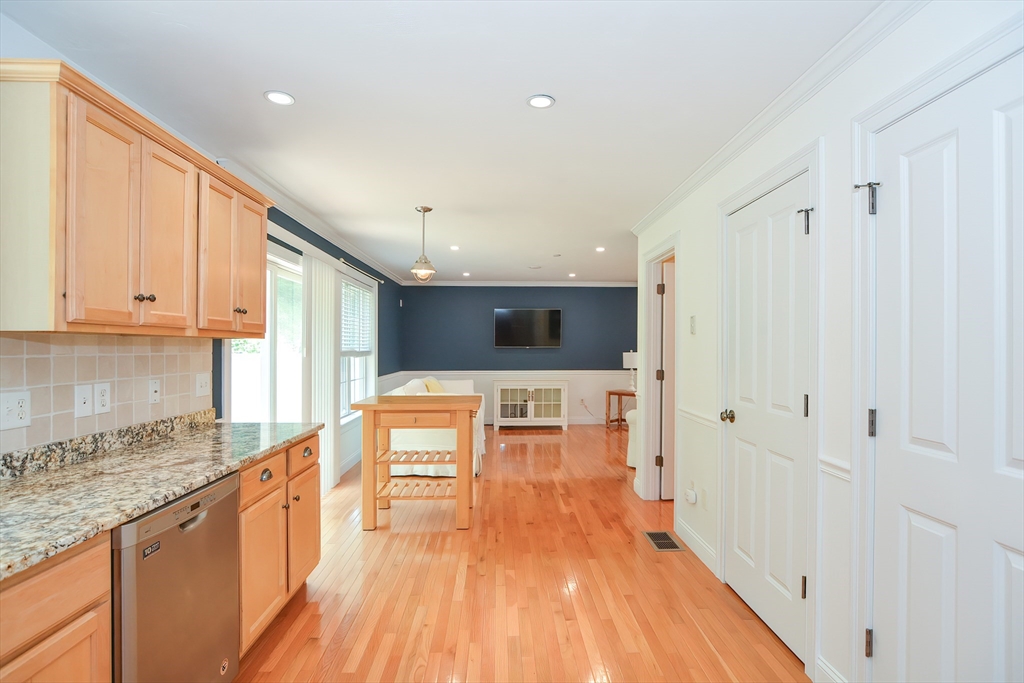 61 Providence Road, Unit 2 Grafton, MA 01519 - Photo 12 of 35 a view of a kitchen with kitchen island a sink wooden floor and stainless steel appliances