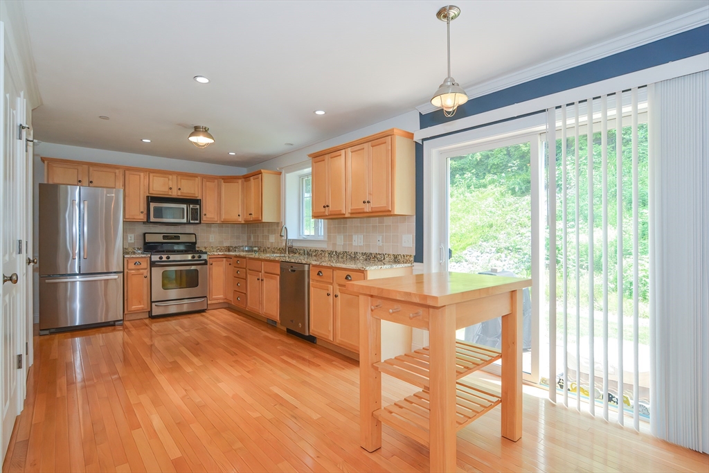 61 Providence Road, Unit 2 Grafton, MA 01519 - Photo 15 of 35 a kitchen with granite countertop a stove a sink and a refrigerator