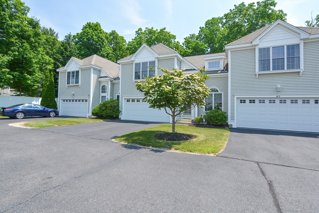 61 Providence Road, Unit 2 Grafton, MA 01519 - Photo 2 of 35 a front view of a house with a yard and garage