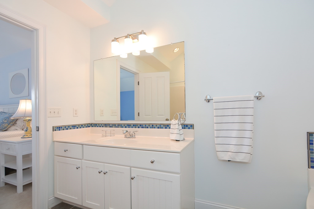 61 Providence Road, Unit 2 Grafton, MA 01519 - Photo 21 of 35 a bathroom with a sink vanity and a mirror