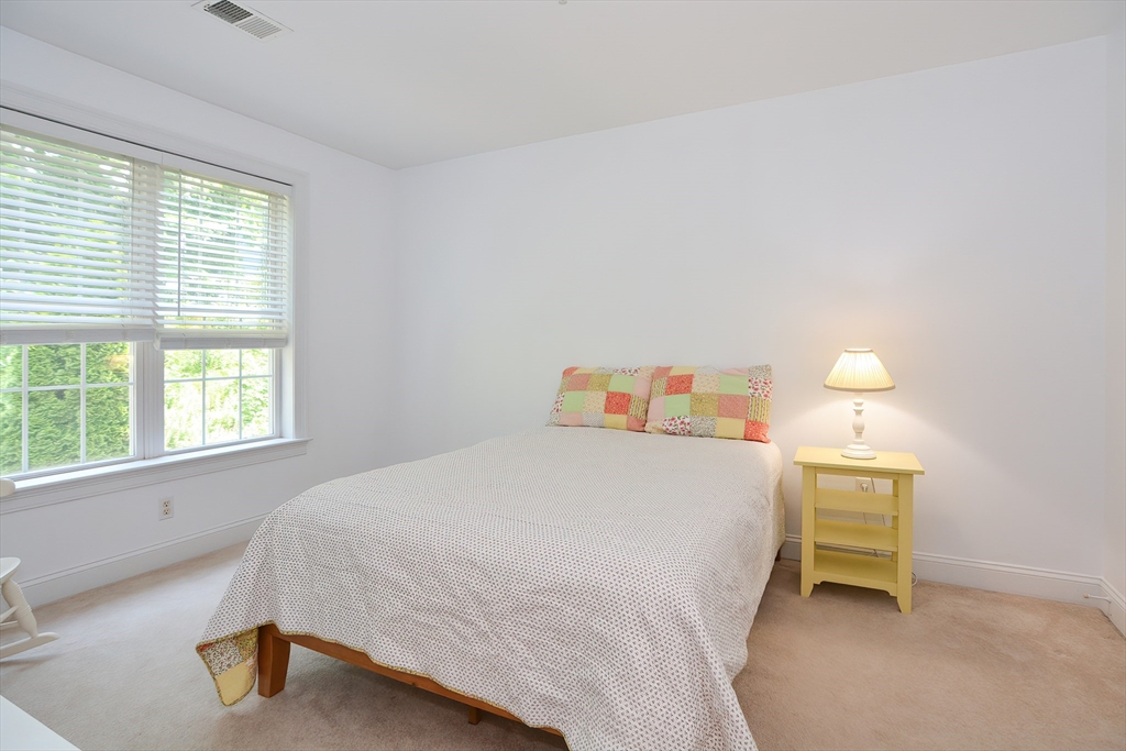 61 Providence Road, Unit 2 Grafton, MA 01519 - Photo 28 of 35 a bedroom with a bed and a lamp next to a window