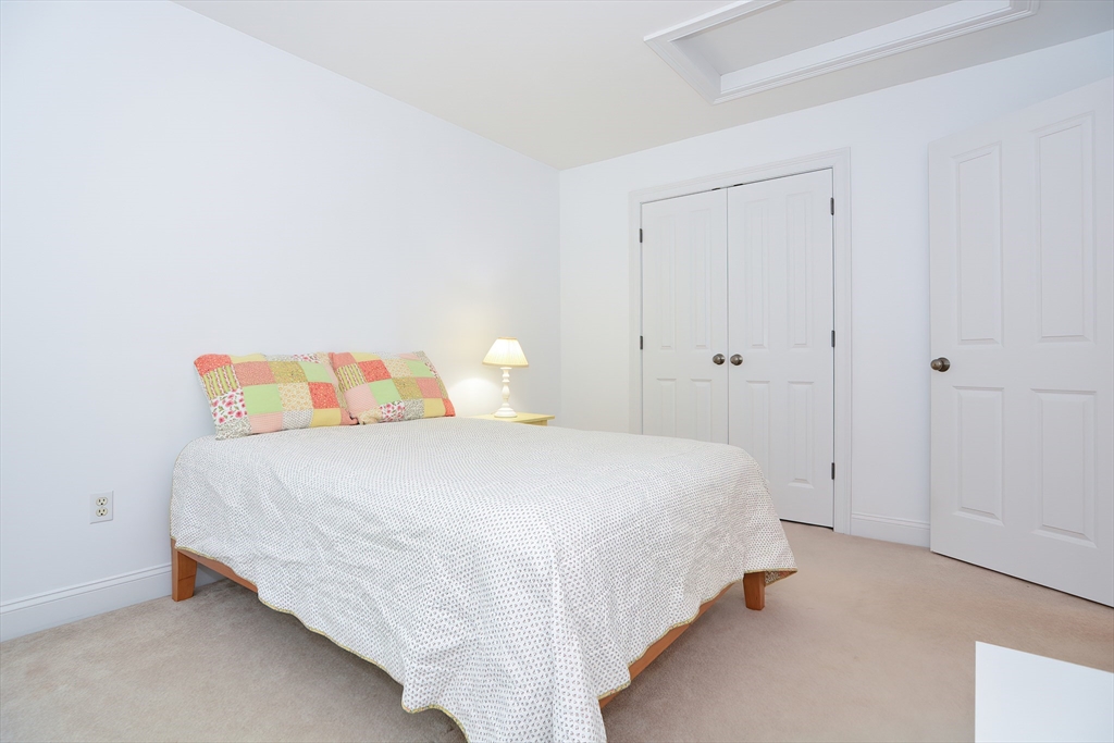 61 Providence Road, Unit 2 Grafton, MA 01519 - Photo 29 of 35 a bedroom with a bed and a window