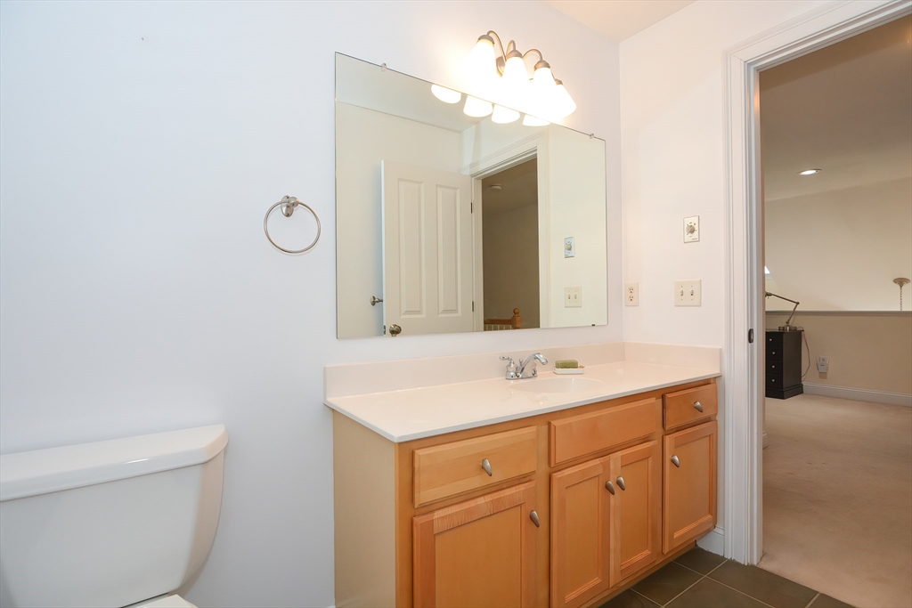 61 Providence Road, Unit 2 Grafton, MA 01519 - Photo 31 of 35 a bathroom with a sink vanity and a mirror
