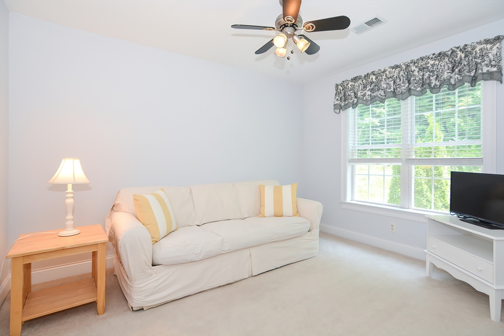 61 Providence Road, Unit 2 Grafton, MA 01519 - Photo 32 of 35 a living room with furniture and a flat screen tv