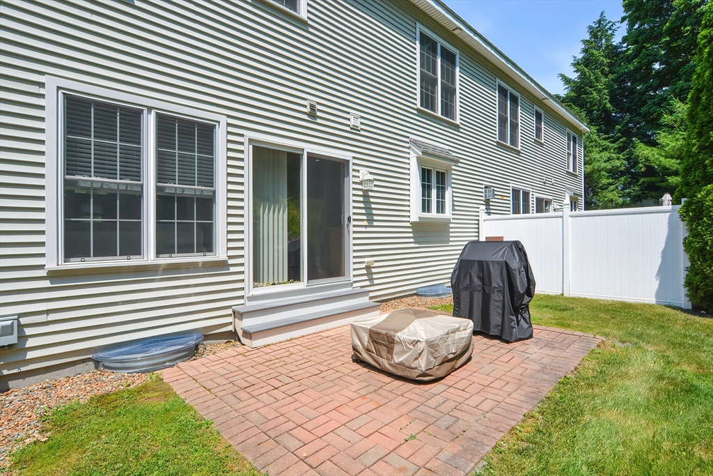61 Providence Road, Unit 2 Grafton, MA 01519 - Photo 5 of 35 a view of a house with a backyard and wooden fence