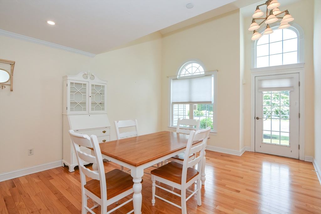 61 Providence Road, Unit 2 Grafton, MA 01519 - Photo 6 of 35 a view of a dining room with furniture and wooden floor