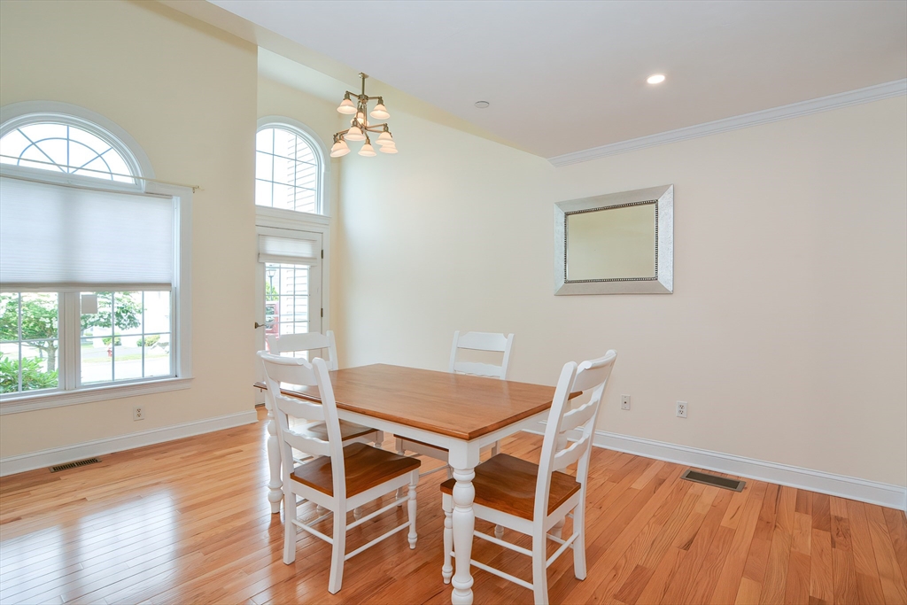 61 Providence Road, Unit 2 Grafton, MA 01519 - Photo 7 of 35 a view of a dining room with furniture and wooden floor