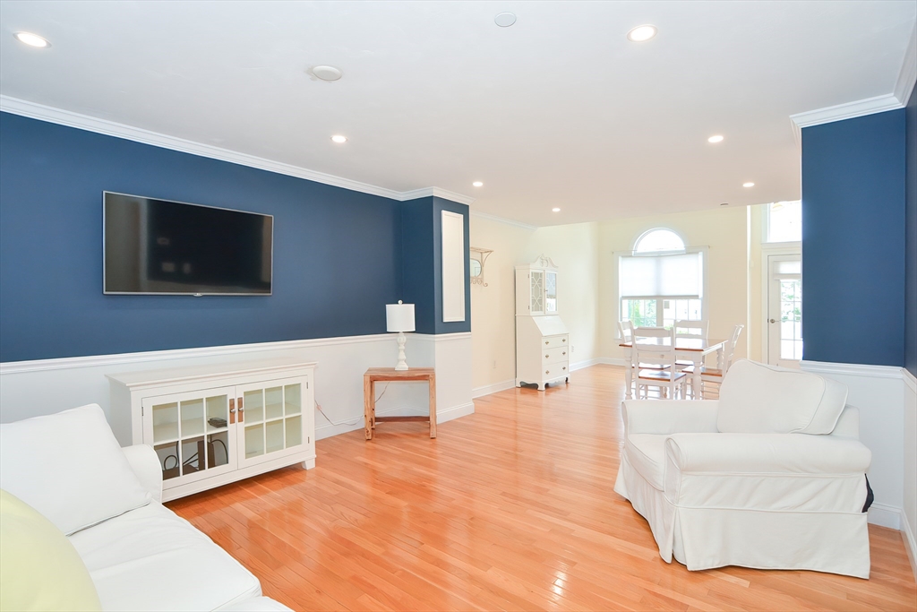 61 Providence Road, Unit 2 Grafton, MA 01519 - Photo 9 of 35 a living room with furniture a flat screen tv and wooden floor