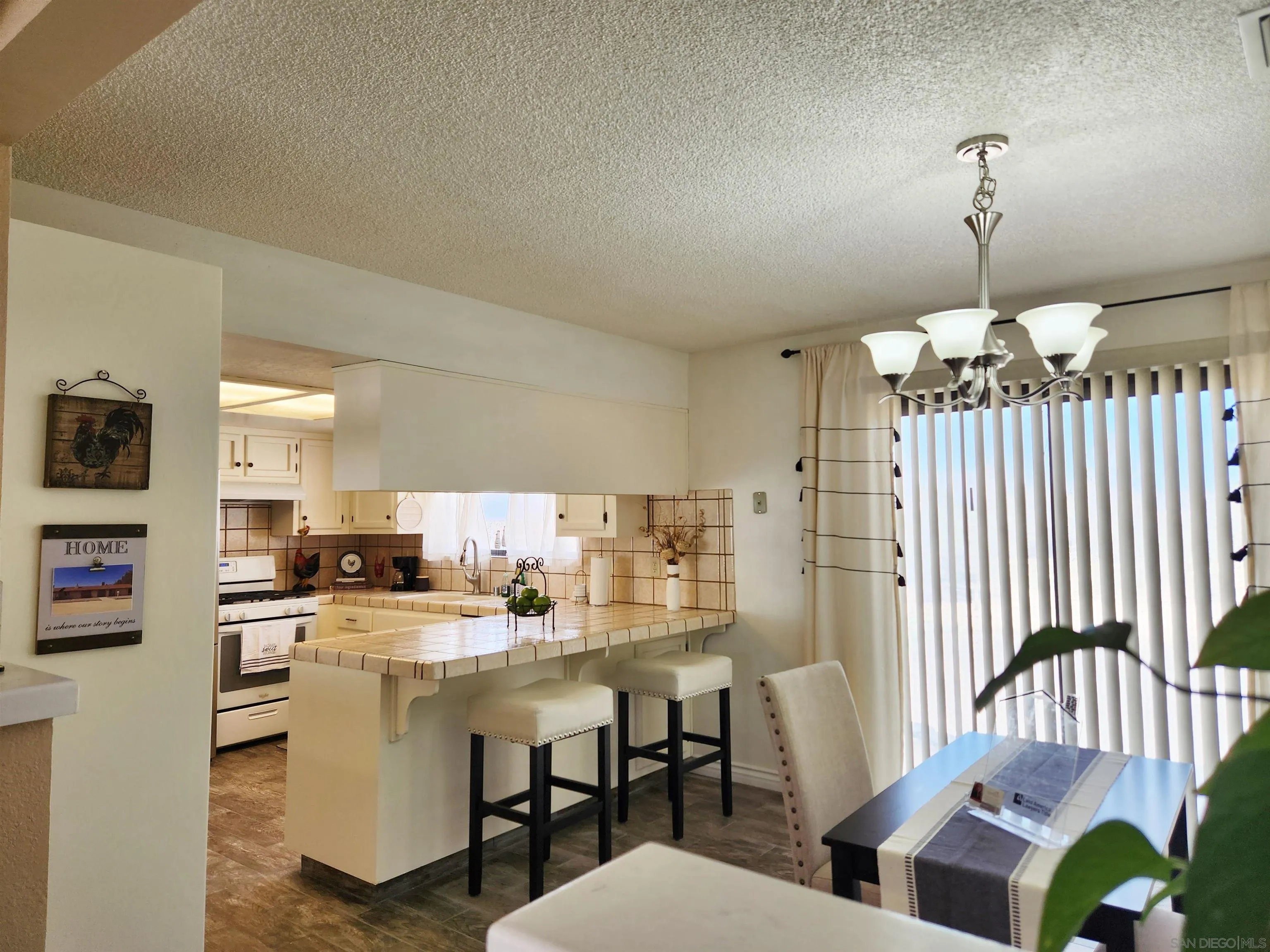 3628 Alene Avenue Ridgecrest, CA 93555 - Photo 12 of 46 a dining room with furniture and a chandelier