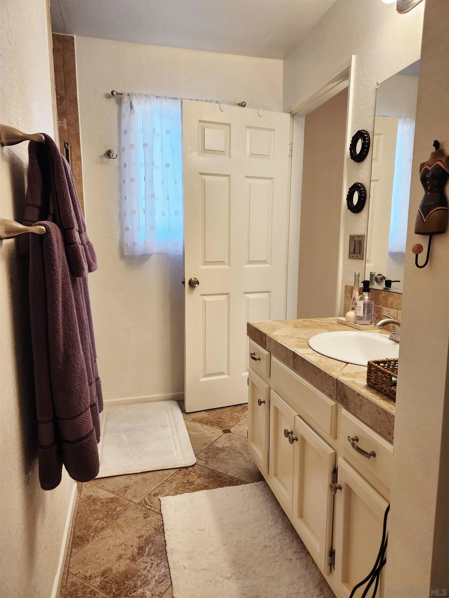 3628 Alene Avenue Ridgecrest, CA 93555 - Photo 31 of 46 a bathroom with a sink and a mirror