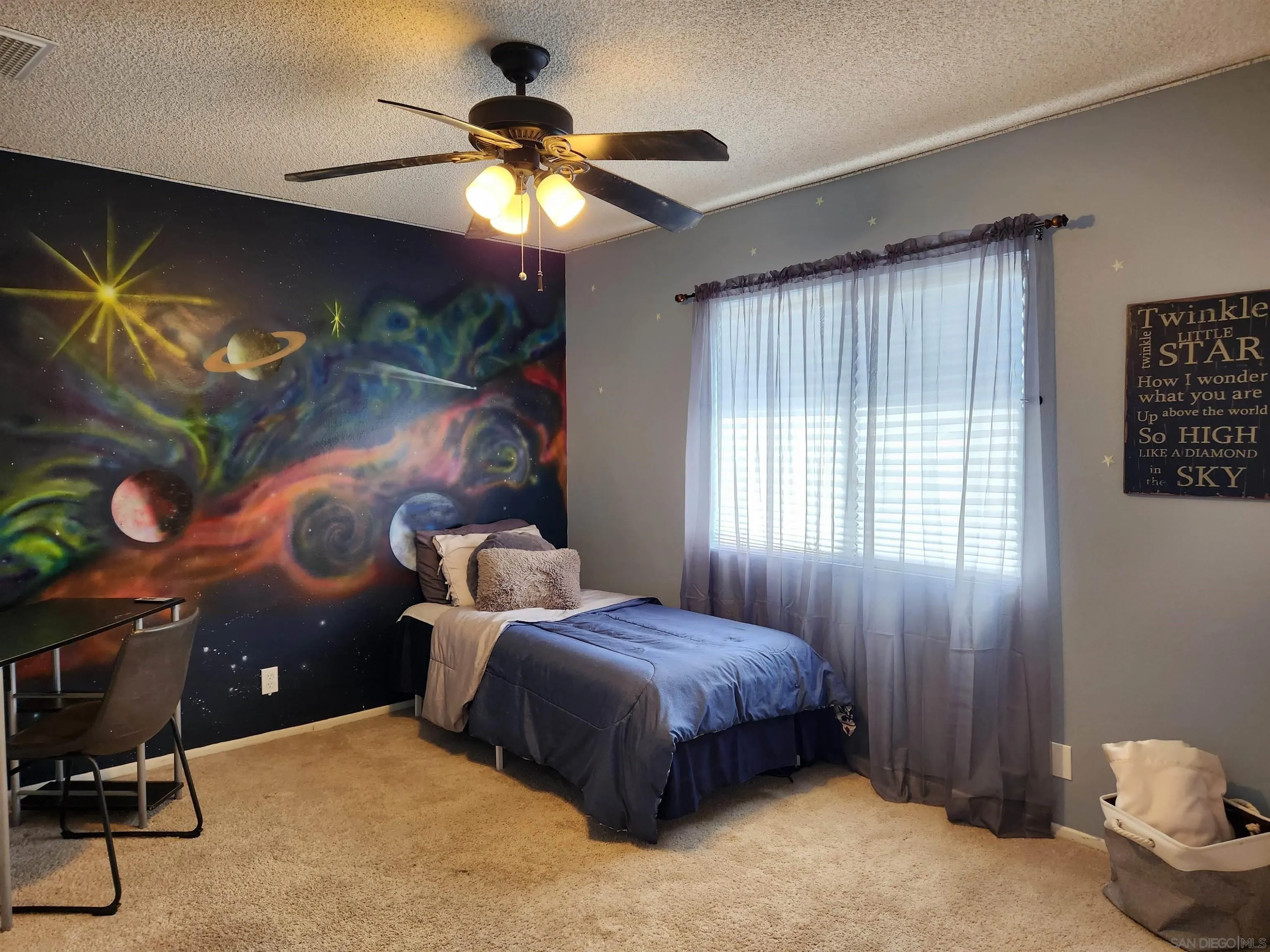 3628 Alene Avenue Ridgecrest, CA 93555 - Photo 32 of 46 a bedroom with a bed and a chandelier