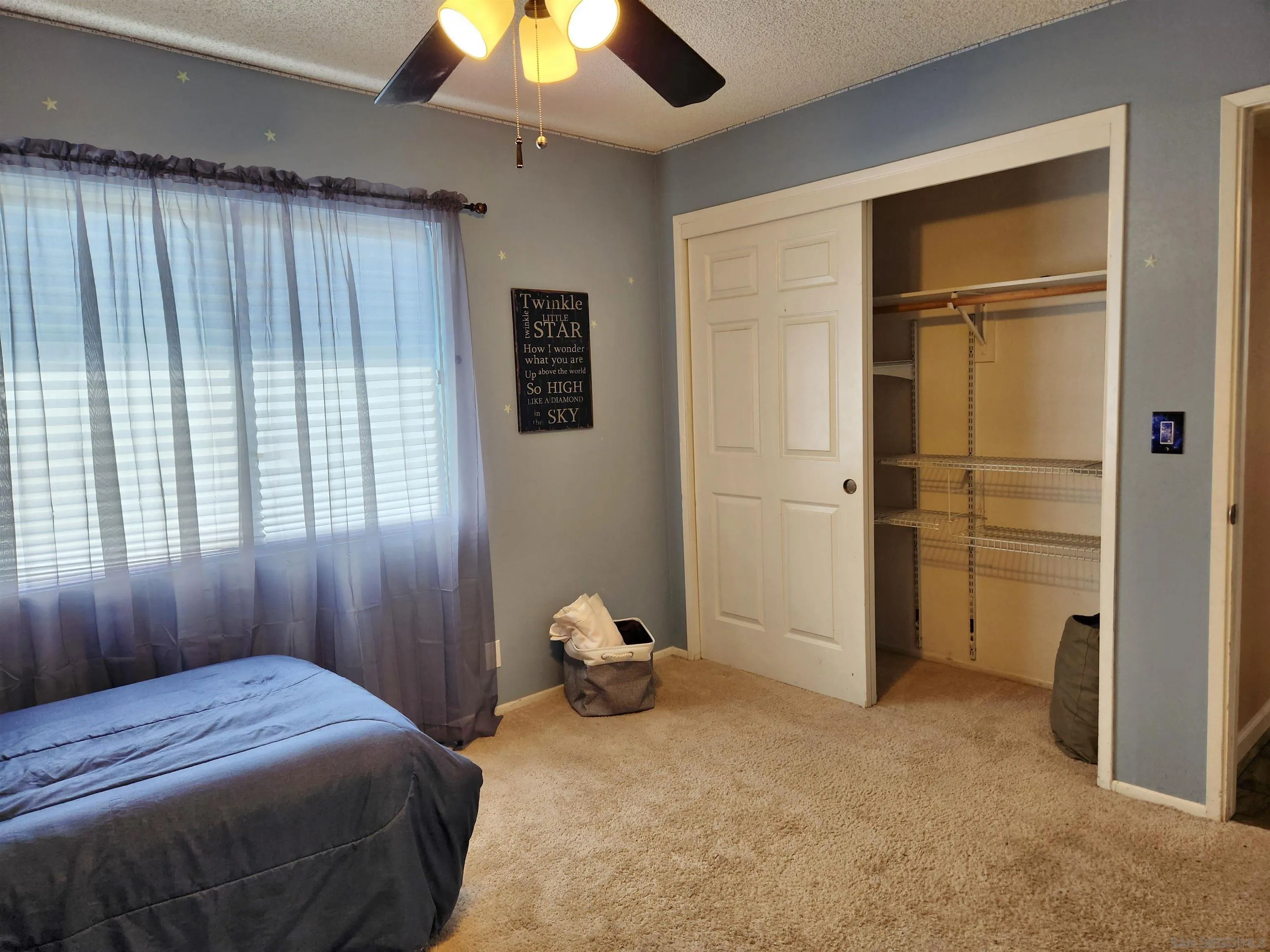 3628 Alene Avenue Ridgecrest, CA 93555 - Photo 33 of 46 a bedroom with a bed and a chandelier
