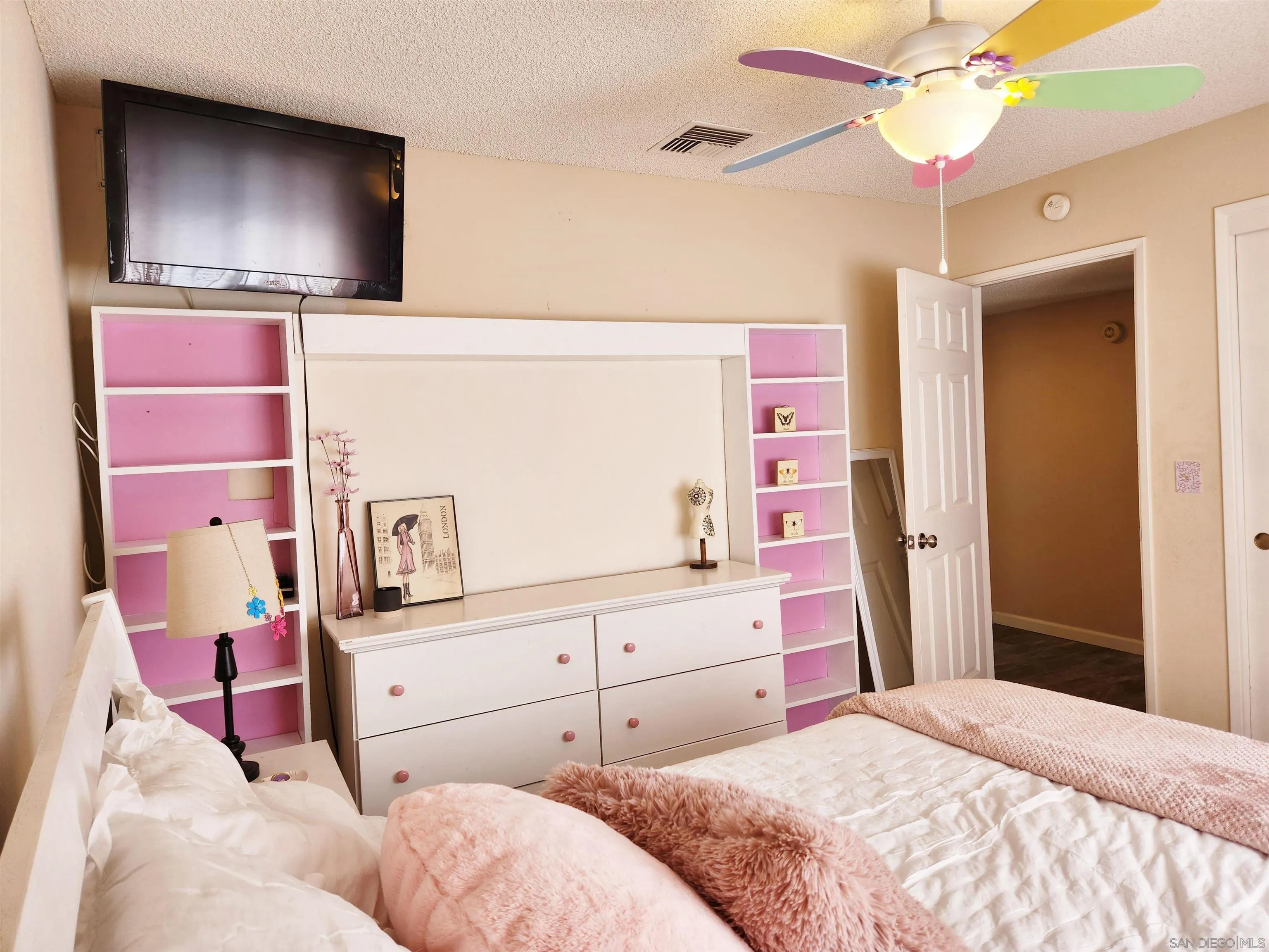 3628 Alene Avenue Ridgecrest, CA 93555 - Photo 35 of 46 a bedroom with a bed and a chandelier