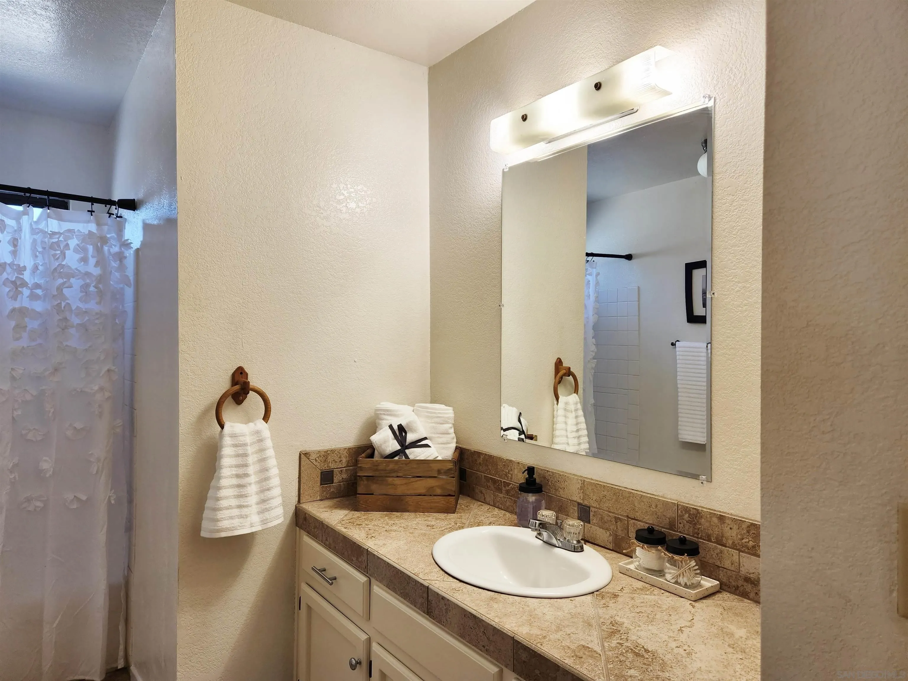 3628 Alene Avenue Ridgecrest, CA 93555 - Photo 37 of 46 a bathroom with a granite countertop sink and a mirror