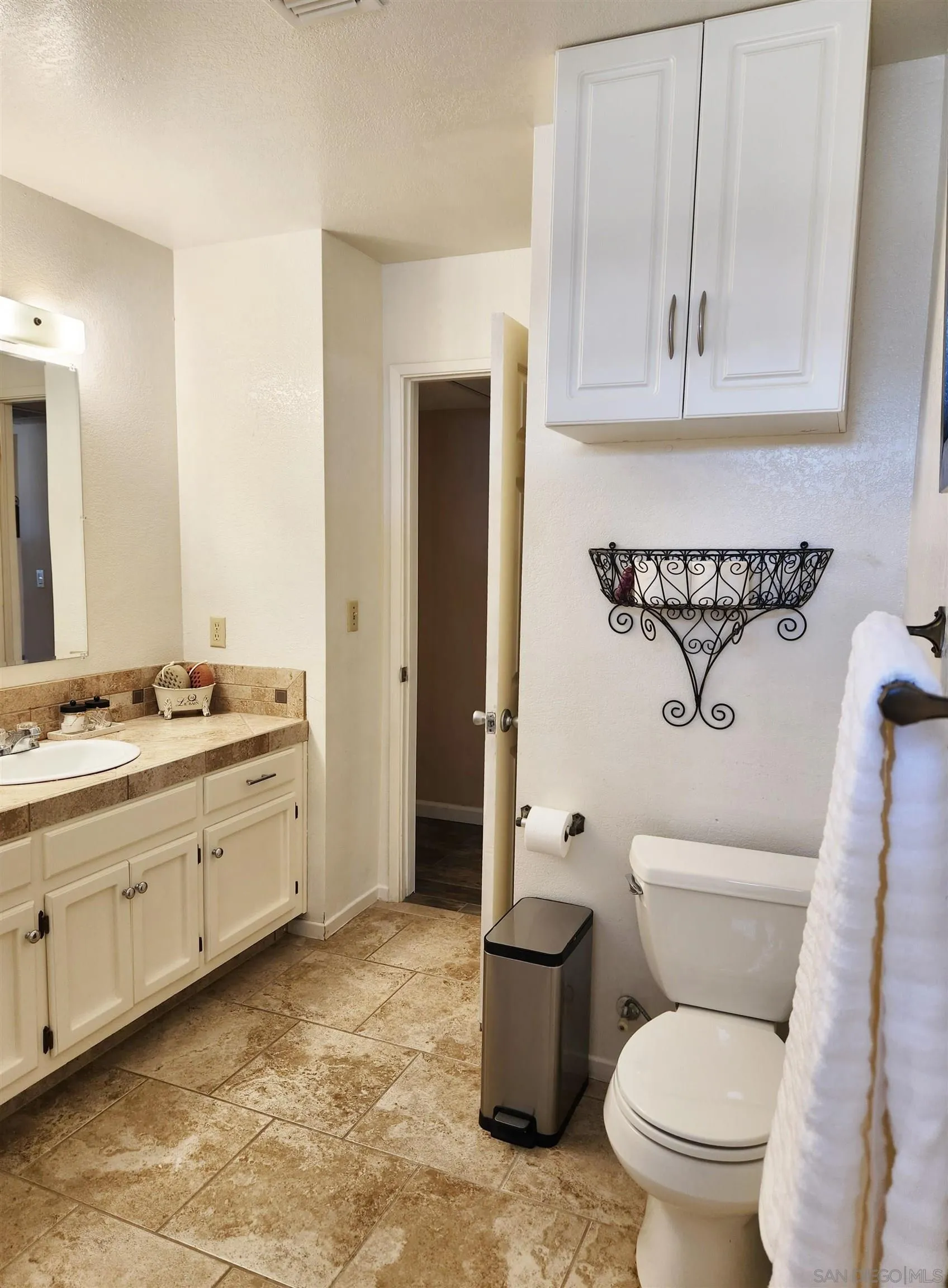 3628 Alene Avenue Ridgecrest, CA 93555 - Photo 38 of 46 a bathroom with a granite countertop toilet sink and mirror