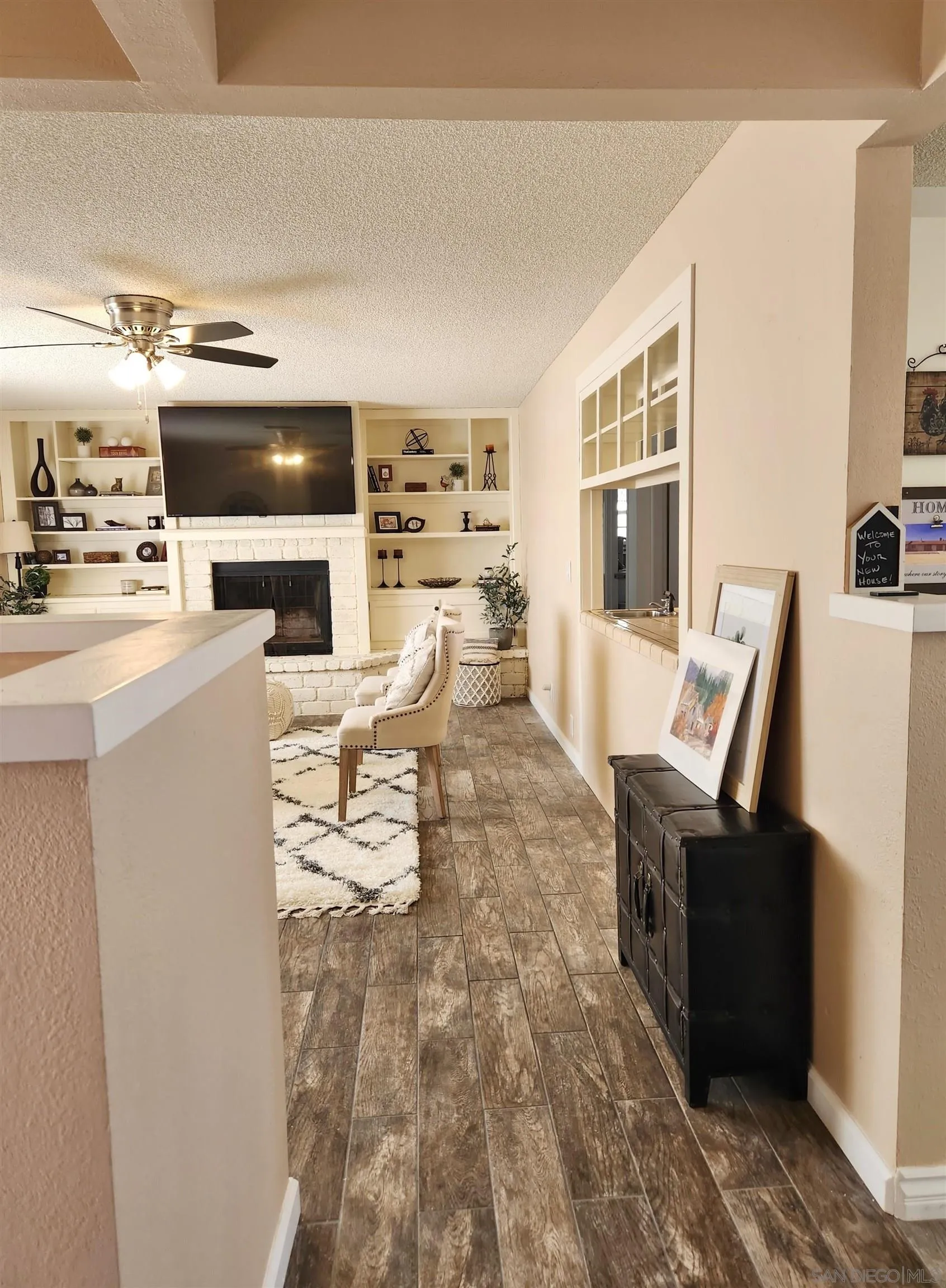 3628 Alene Avenue Ridgecrest, CA 93555 - Photo 5 of 46 a living room with furniture a fireplace and a flat screen tv