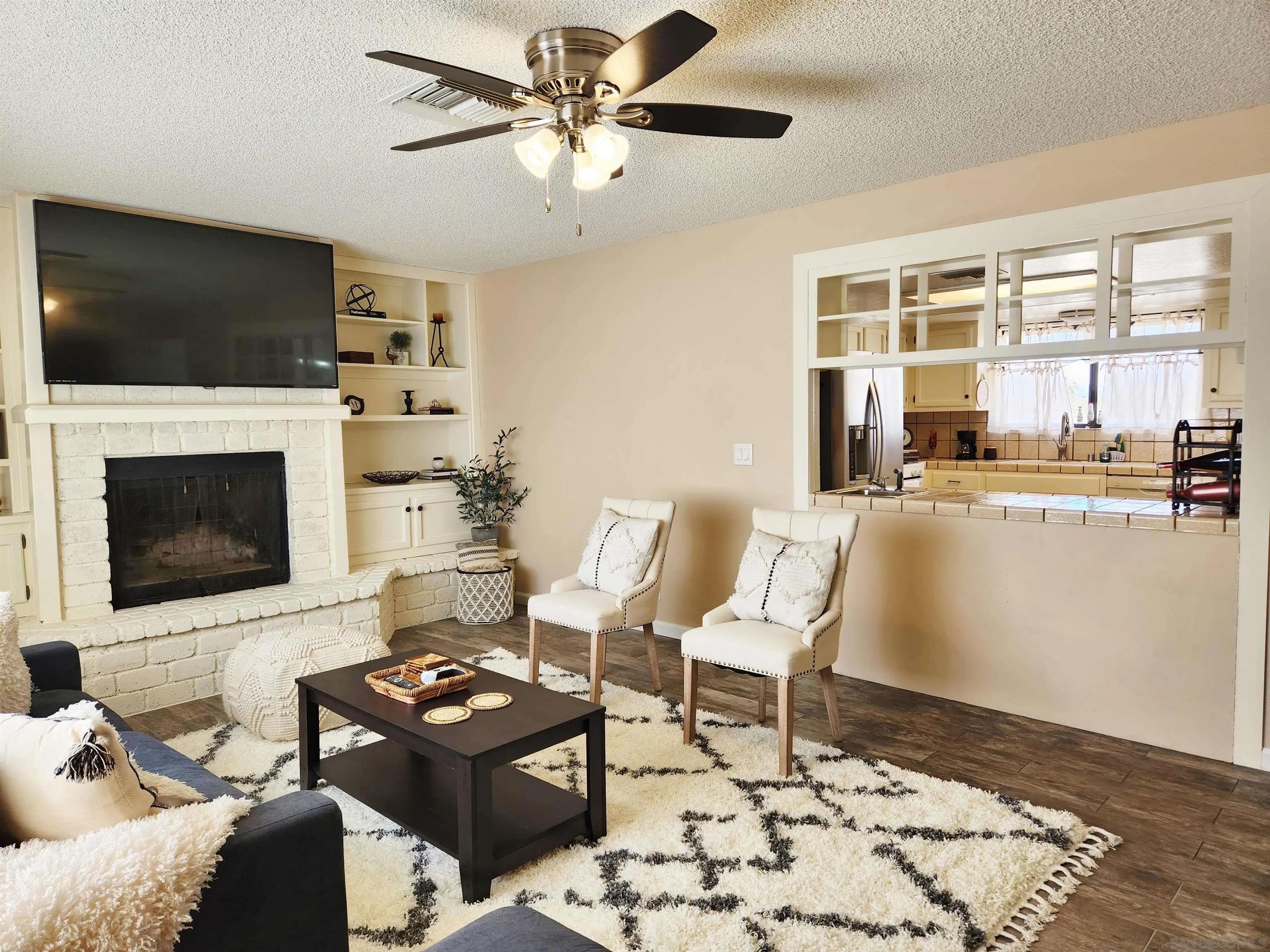3628 Alene Avenue Ridgecrest, CA 93555 - Photo 9 of 46 a living room with furniture a flat screen tv and a fireplace