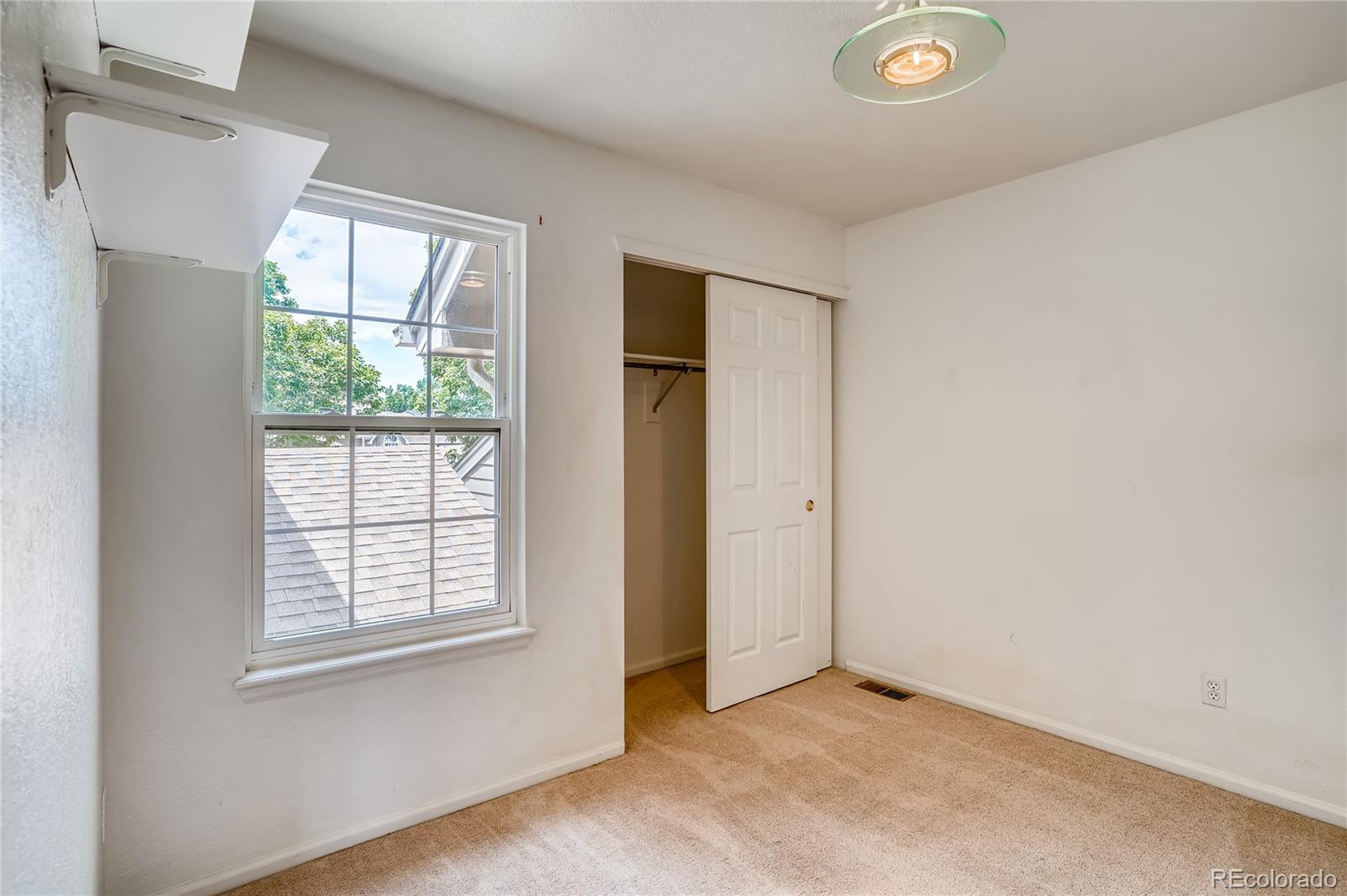 6778 Zenobia Loop, Unit 2 Westminster, CO 80030 - Photo 11 of 13 an empty room with windows