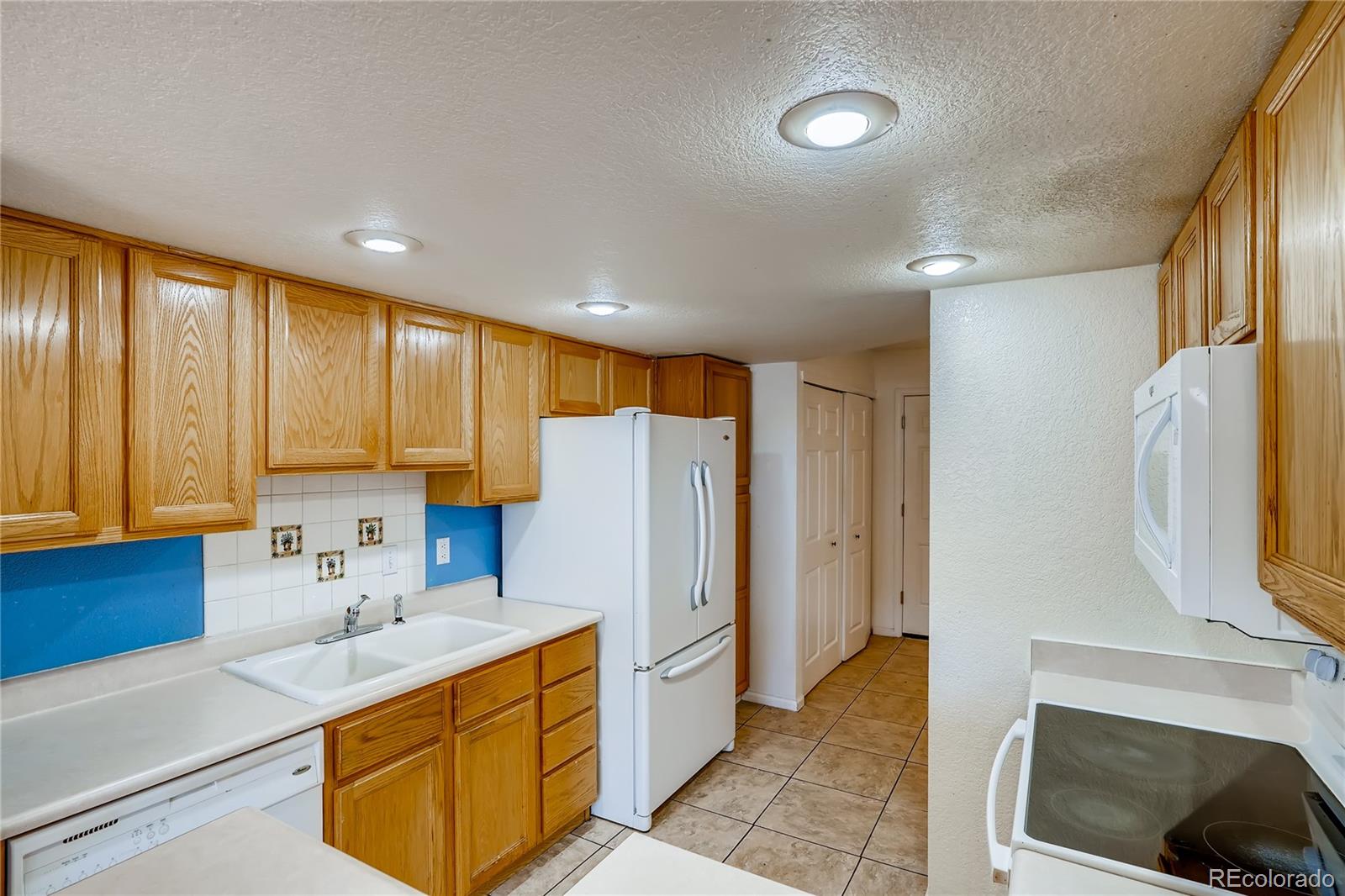 6778 Zenobia Loop, Unit 2 Westminster, CO 80030 - Photo 5 of 13 a kitchen with a sink and a refrigerator