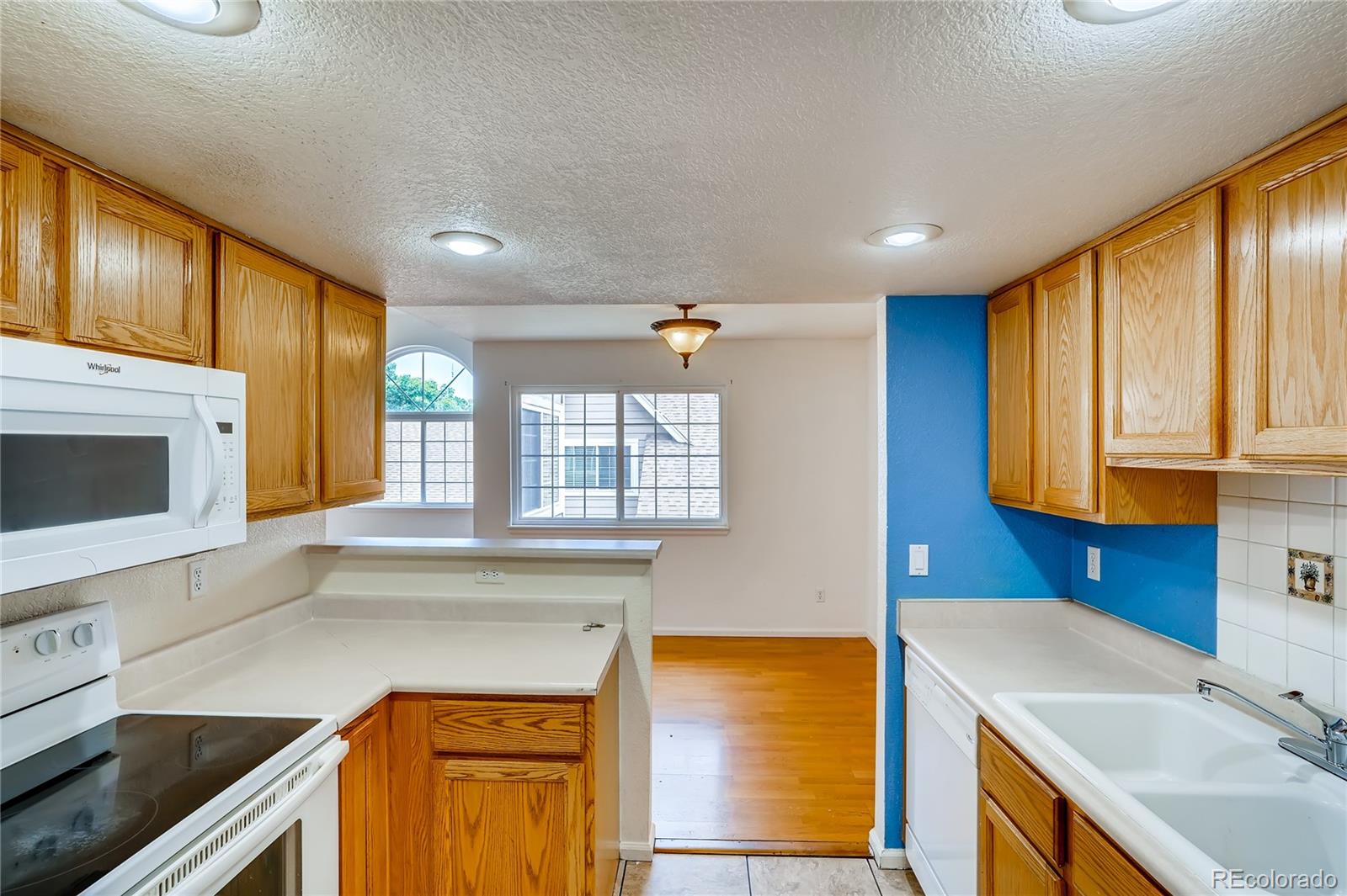 6778 Zenobia Loop, Unit 2 Westminster, CO 80030 - Photo 6 of 13 a kitchen that has a sink and a stove in it