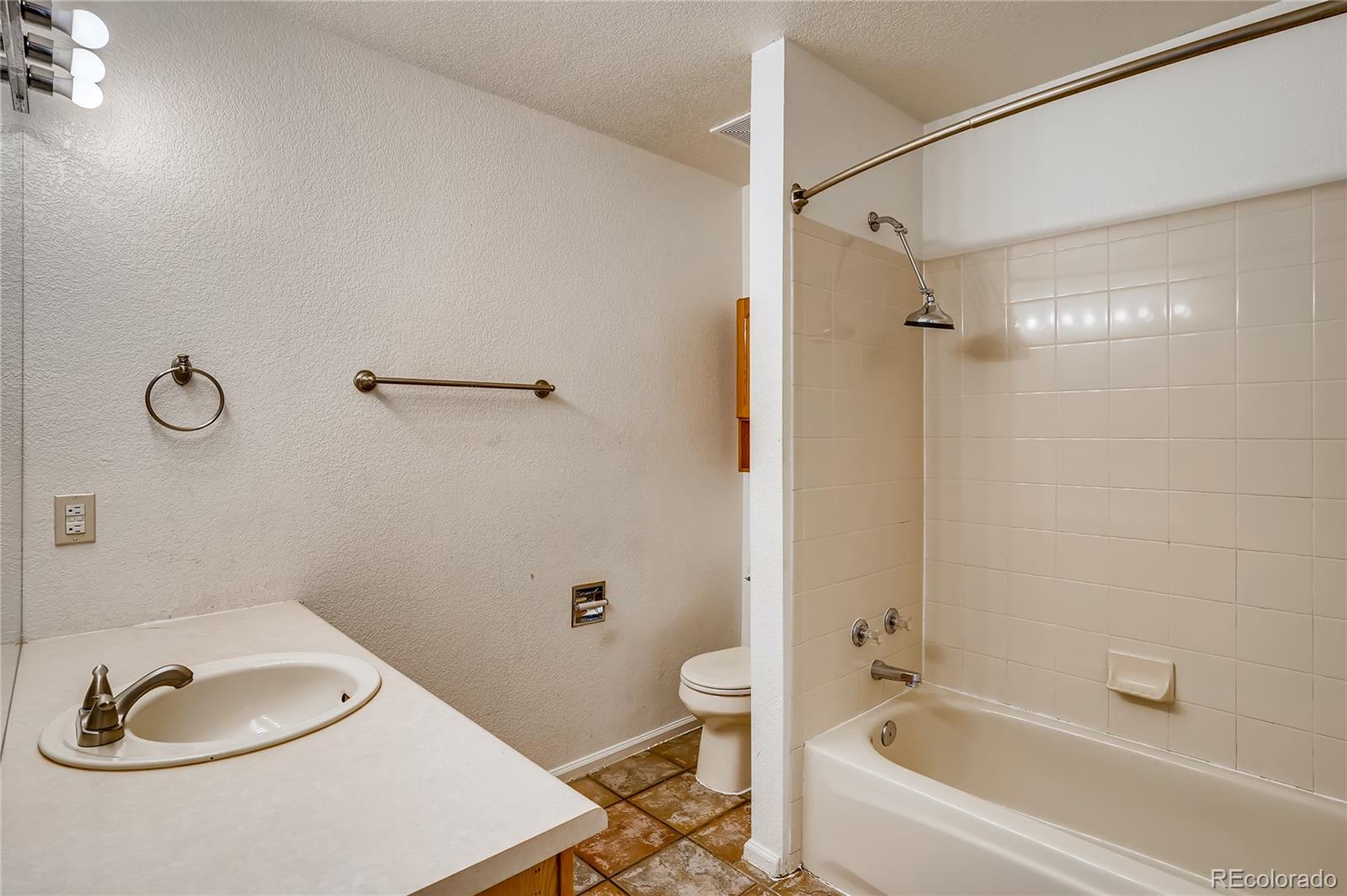 6778 Zenobia Loop, Unit 2 Westminster, CO 80030 - Photo 8 of 13 a bathroom with a sink a toilet and shower