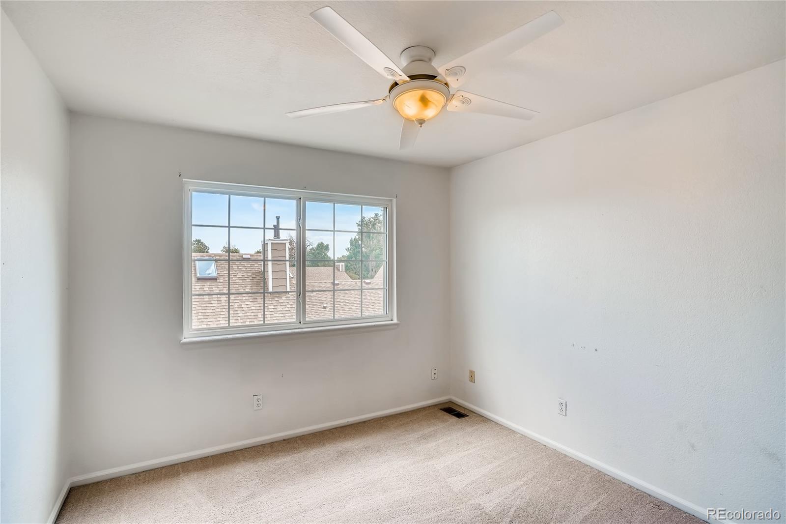 6778 Zenobia Loop, Unit 2 Westminster, CO 80030 - Photo 9 of 13 an empty room with a window